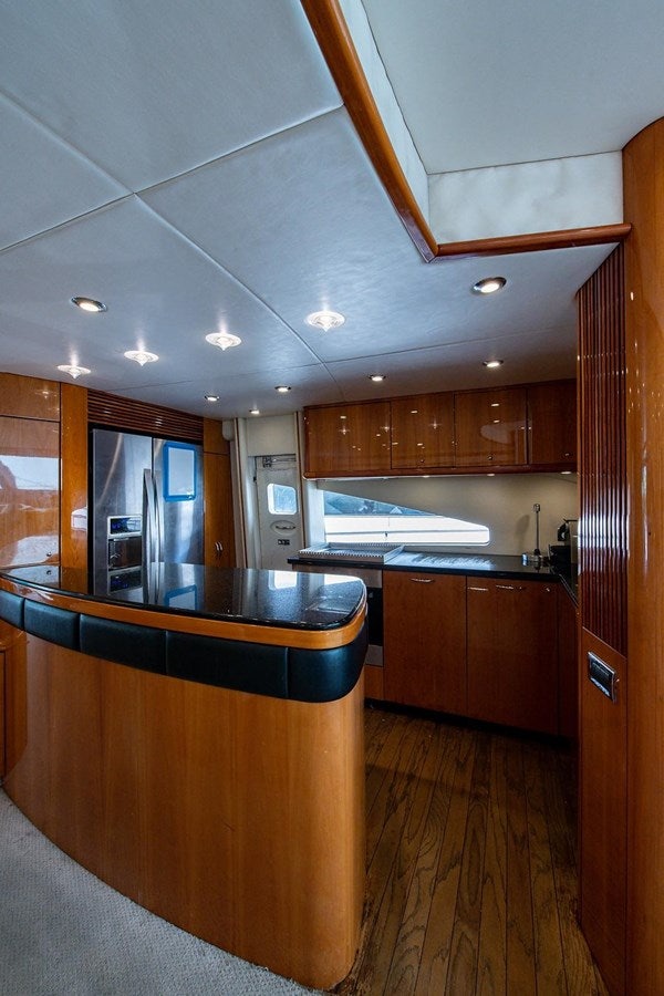 a kitchen with wooden cabinets aboard 82 SUNSEEKER MANHATTAN  Yacht for Sale