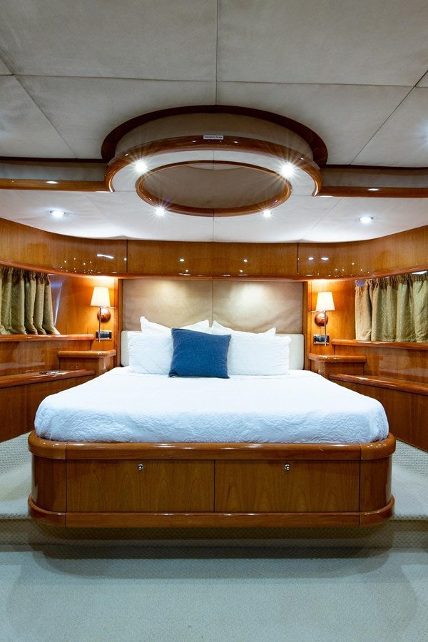 a bed with a chandelier above it aboard 82 SUNSEEKER MANHATTAN  Yacht for Sale