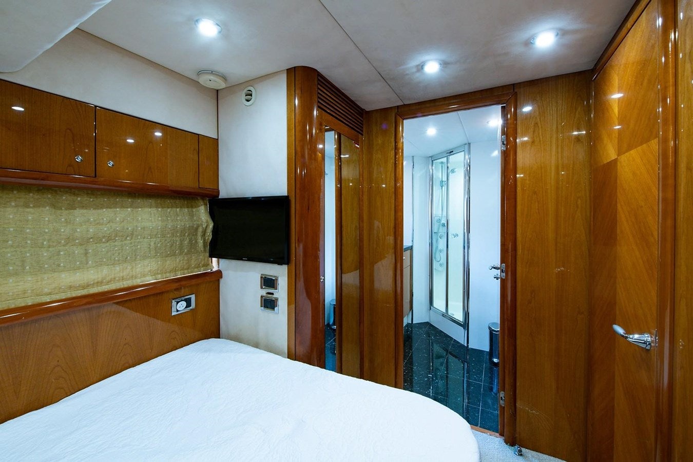 a bedroom with a bed and a closet aboard 82 SUNSEEKER MANHATTAN  Yacht for Sale