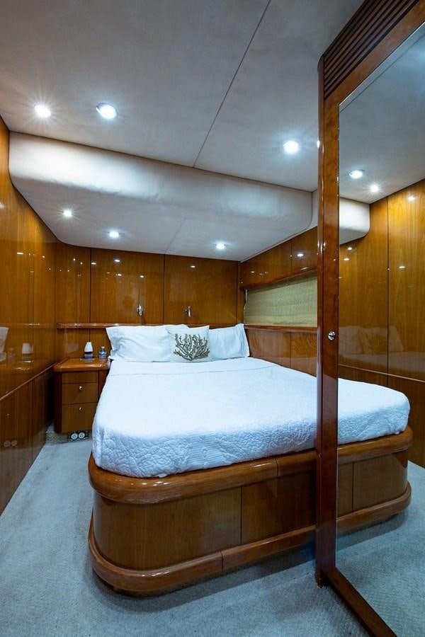 a bed with a wooden frame aboard 82 SUNSEEKER MANHATTAN  Yacht for Sale