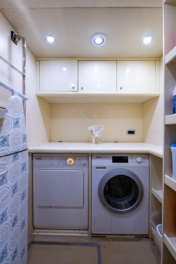 a washer and dryer in a laundry room aboard 82 SUNSEEKER MANHATTAN  Yacht for Sale