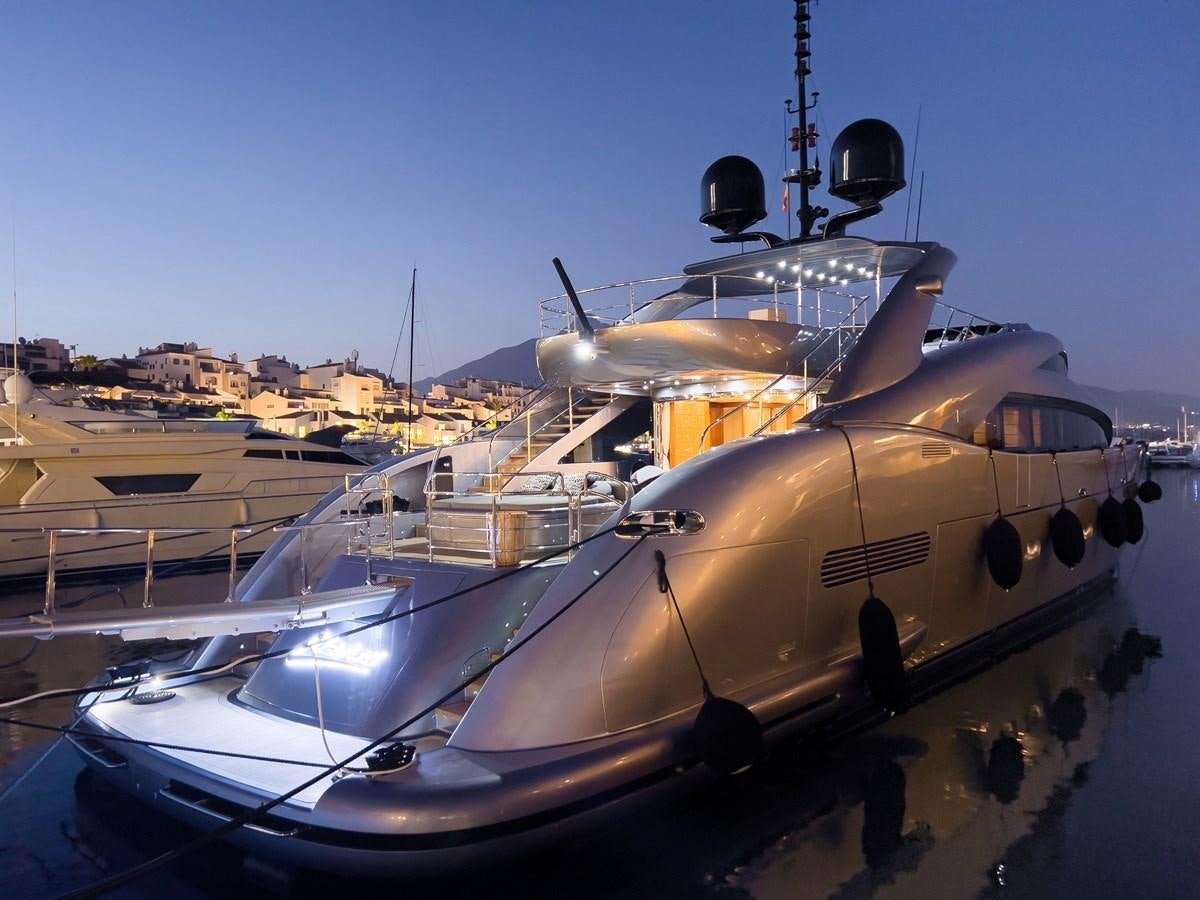 a large military ship docked aboard MATSU Yacht for Sale
