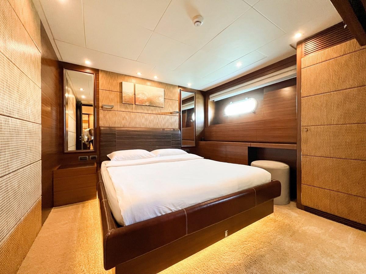 a room with a bed and a mirror aboard MATSU Yacht for Sale