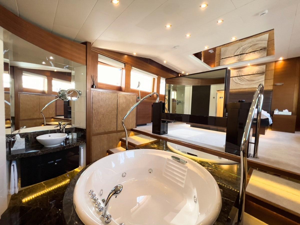 a bathroom with a tub sink and mirror aboard MATSU Yacht for Sale
