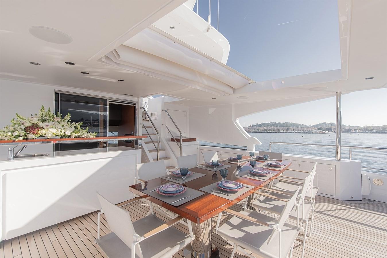 a large open area with a table and chairs and a large window aboard ASLAN Yacht for Sale