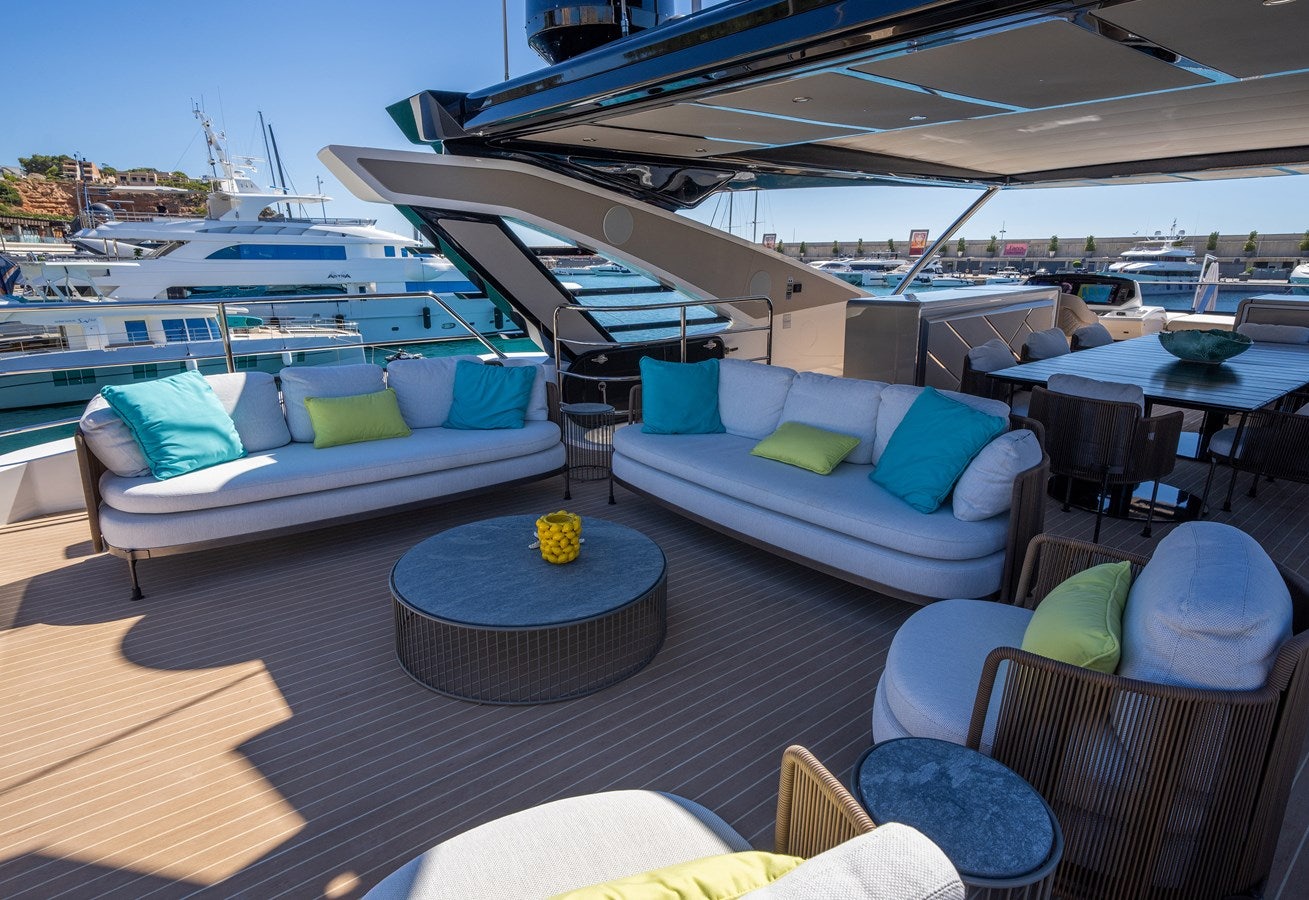 a large patio with a table and chairs on it aboard BANDAZUL Yacht for Sale