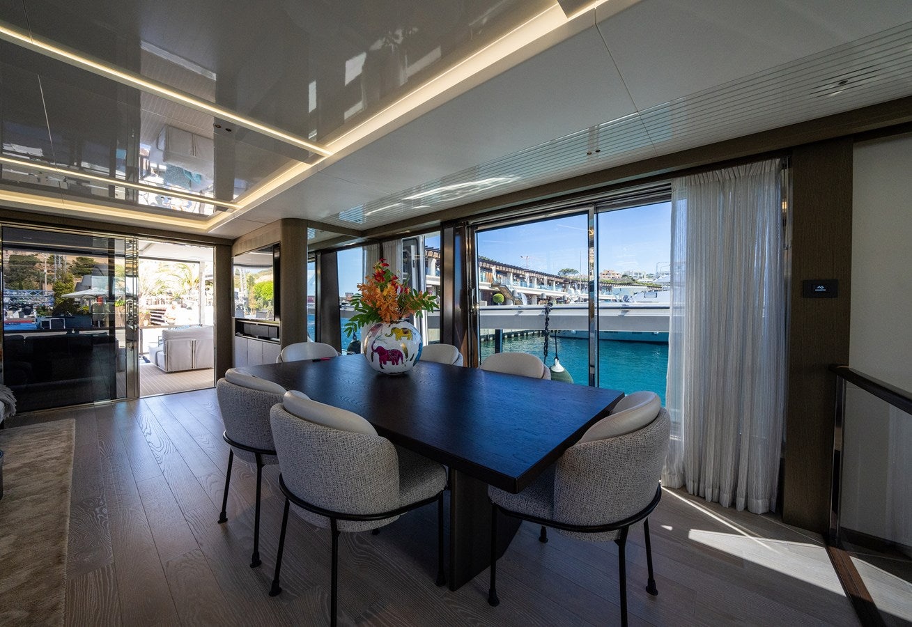 a large dining table in a room aboard BANDAZUL Yacht for Sale