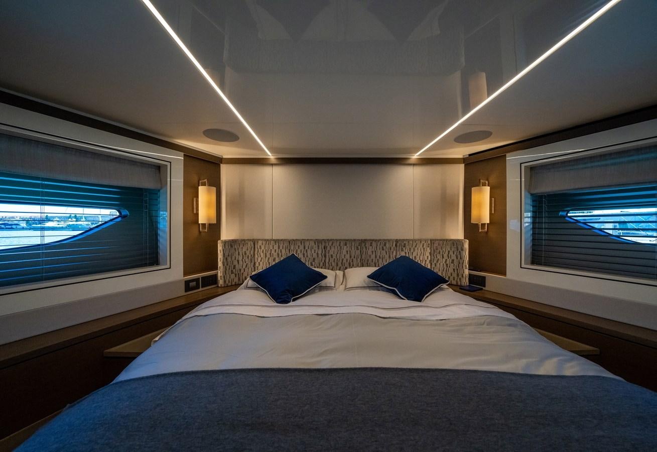 a bed with a blue pillow aboard BANDAZUL Yacht for Sale