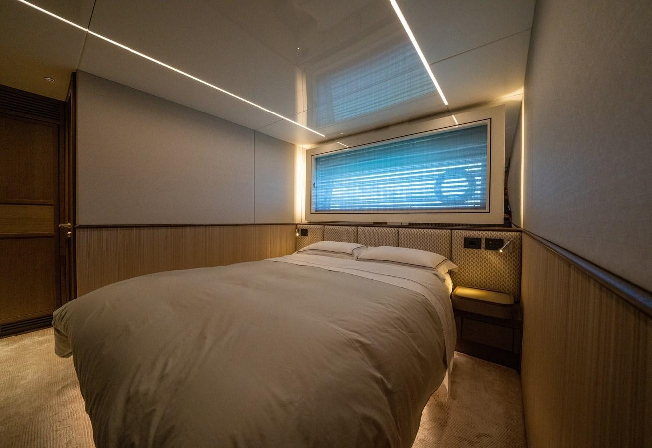 a bedroom with a bed and a television aboard BANDAZUL Yacht for Sale