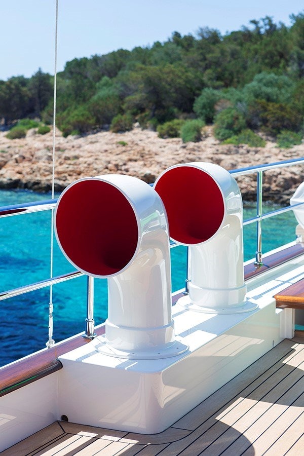 a red and white balloon on a white stand by a pool aboard DARWIN Yacht for Sale