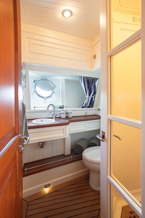 a bathroom with a sink and a mirror aboard DARWIN Yacht for Sale