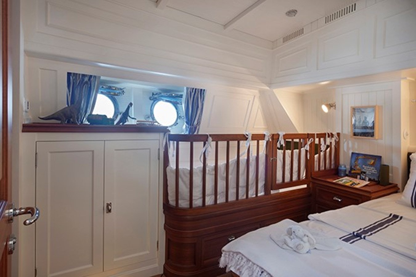 a small bedroom with a bed and a window aboard DARWIN Yacht for Sale