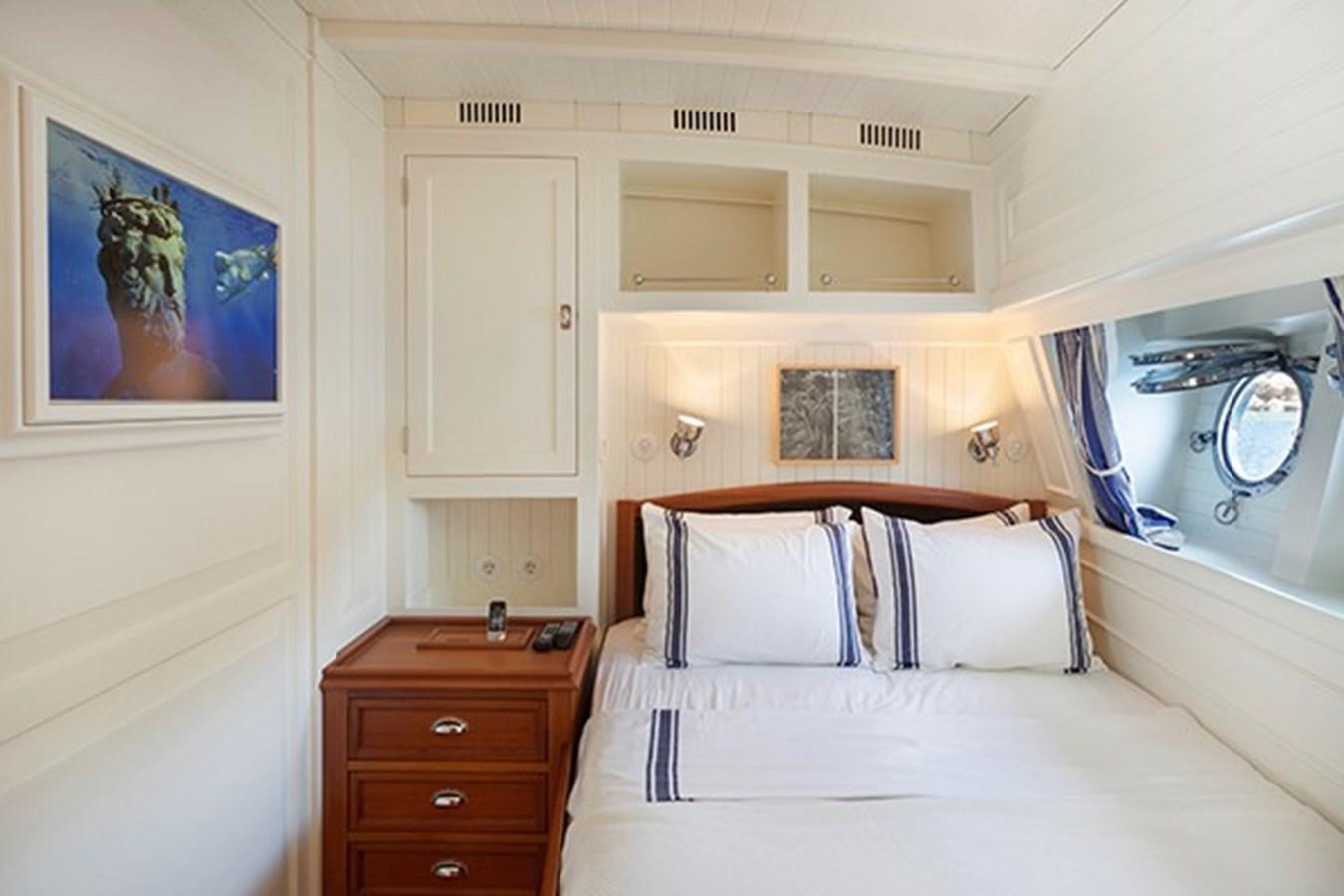 a bedroom with a large mirror aboard DARWIN Yacht for Sale