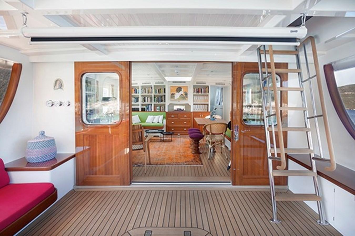 a room with a ladder and chairs aboard DARWIN Yacht for Sale