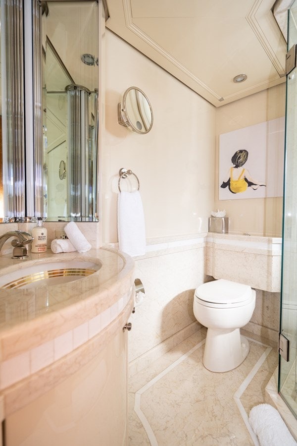 a bathroom with a sink toilet and a mirror aboard SEA CLASS Yacht for Sale