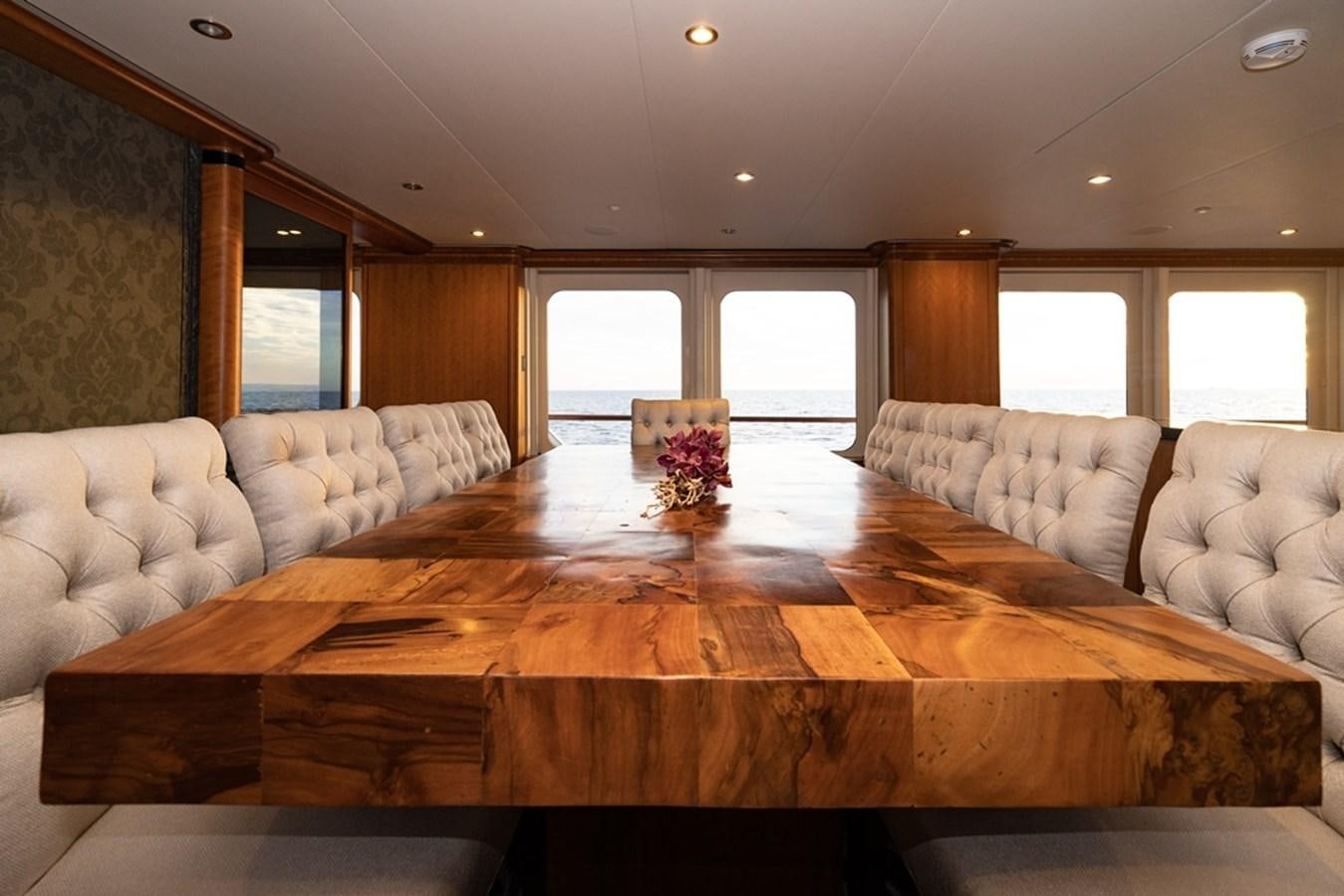 a large living room with a large table and couches aboard SEA CLASS Yacht for Sale