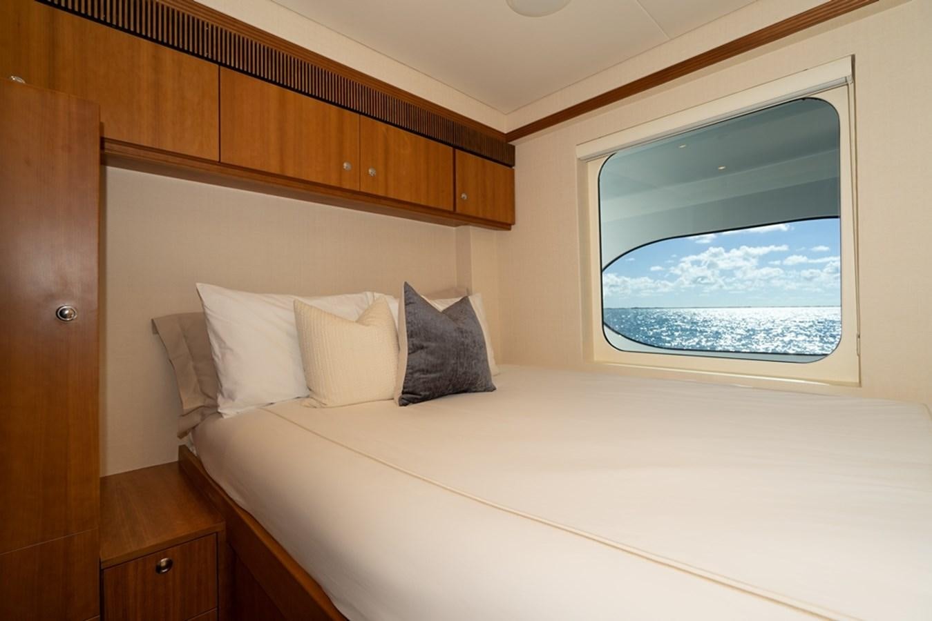 a bed with a white sheet and pillows aboard SEA CLASS Yacht for Sale