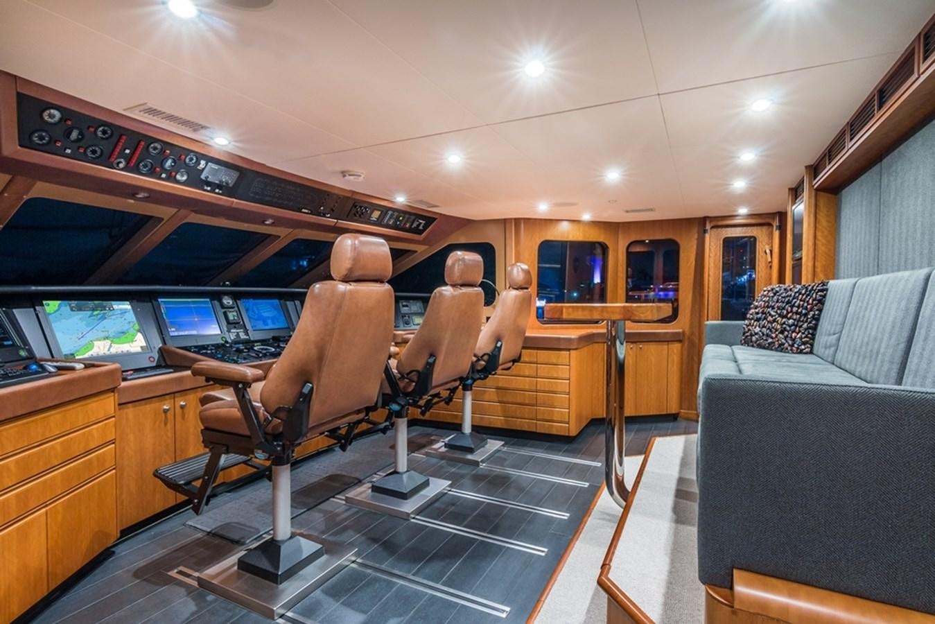 a person sitting in a chair in a room with a tv and furniture aboard SEA CLASS Yacht for Sale