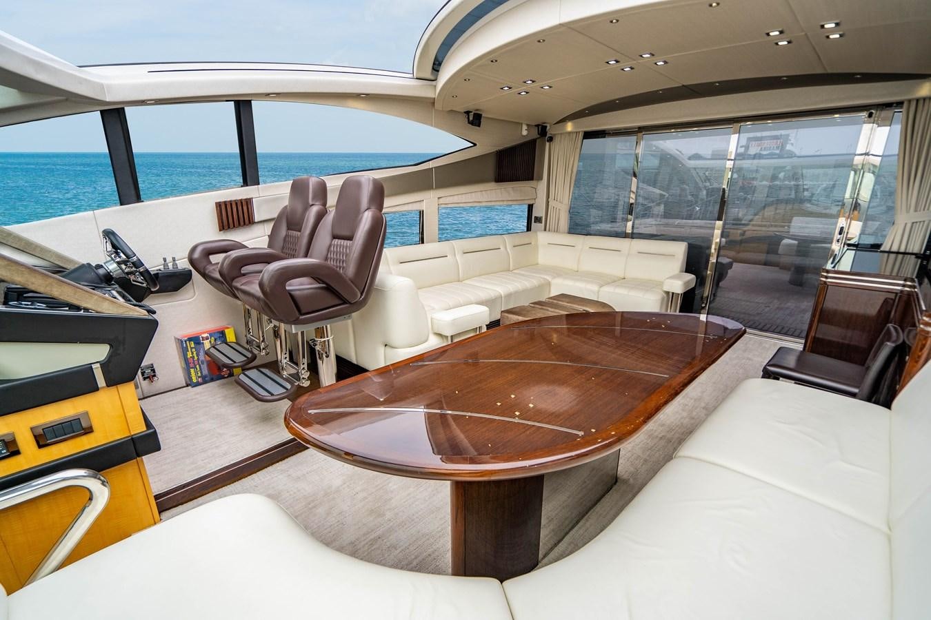 a room with a table and chairs aboard YOLO Yacht for Sale