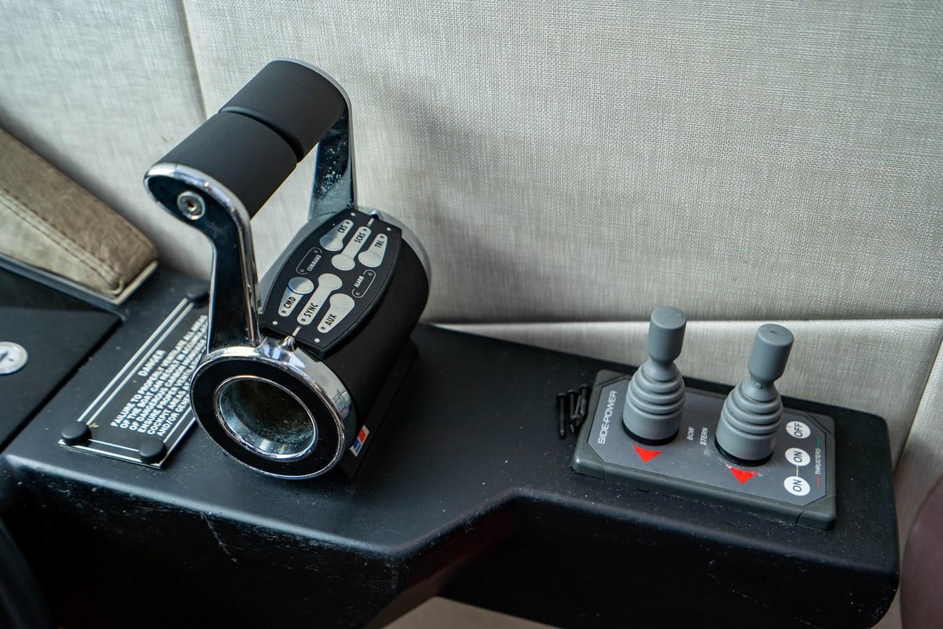 a car stereo and a telephone on a table aboard YOLO Yacht for Sale