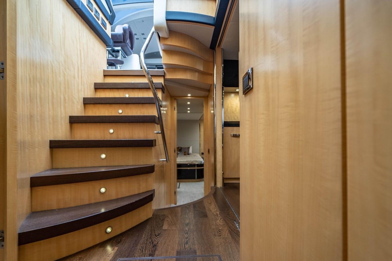 a wooden staircase in a room aboard YOLO Yacht for Sale