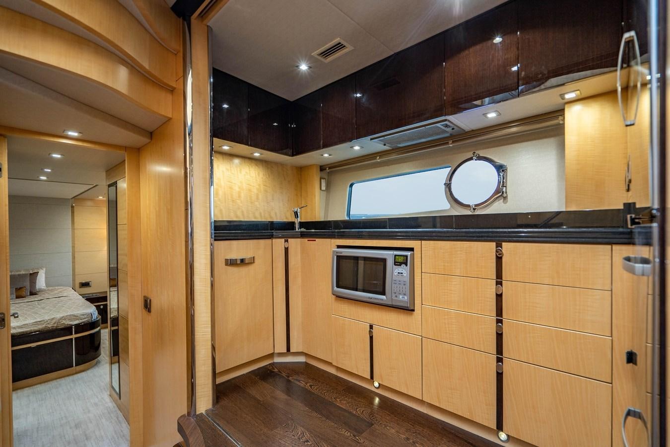 a room with wooden cabinets aboard YOLO Yacht for Sale