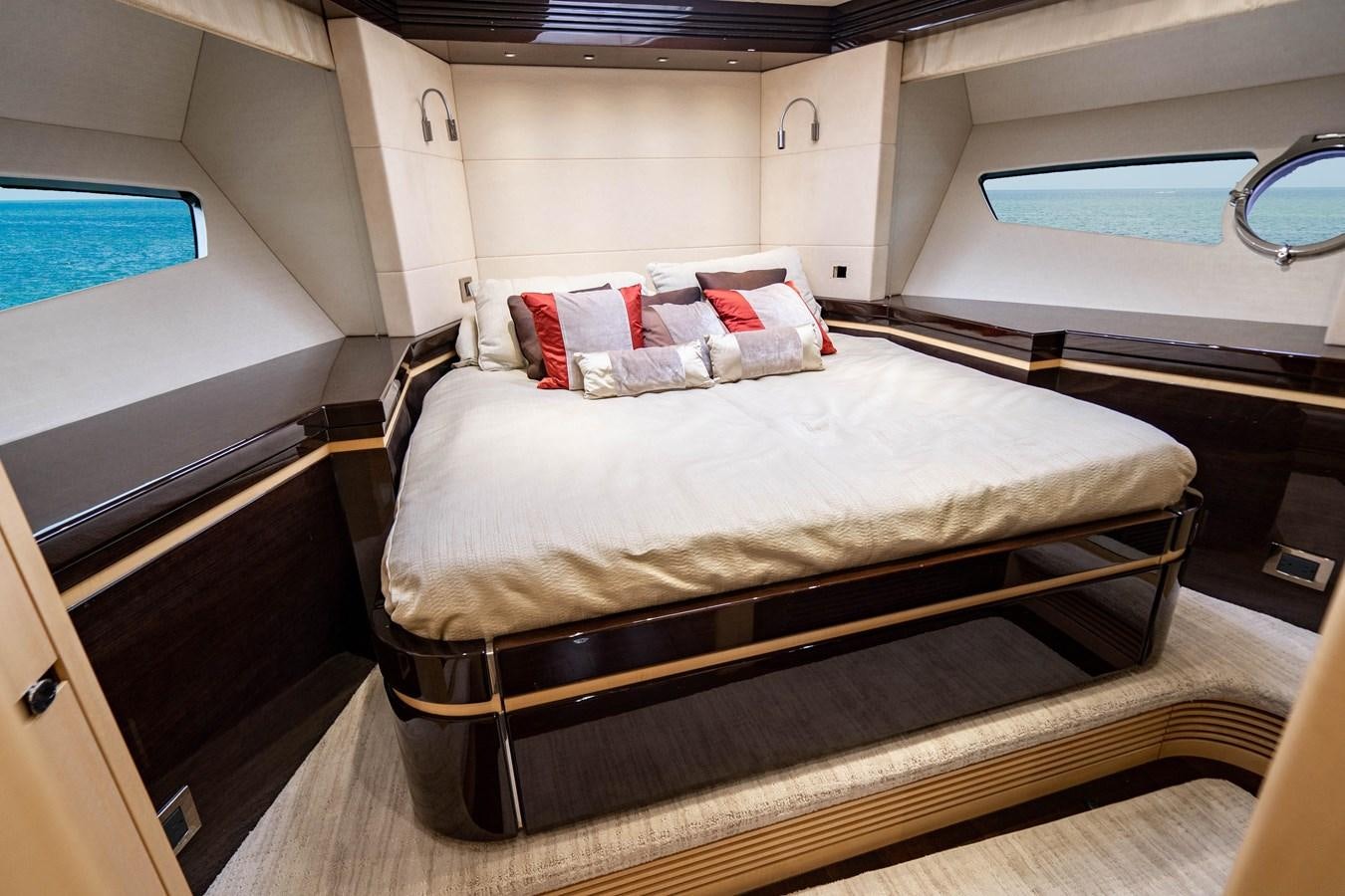a bed in a room aboard YOLO Yacht for Sale