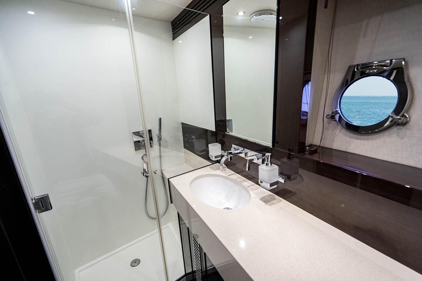 a bathroom with a large mirror aboard YOLO Yacht for Sale