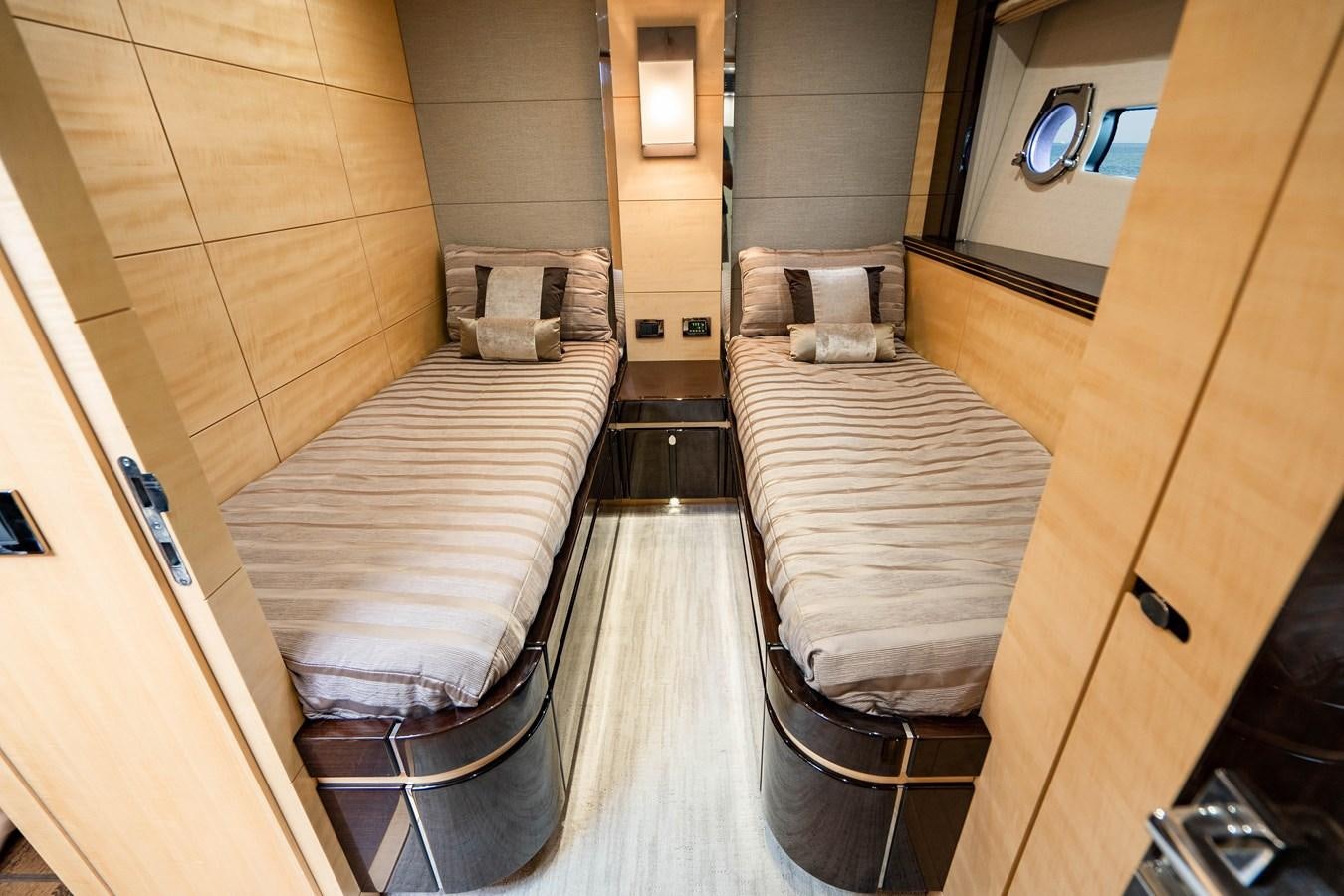 a room with a bed and a chair aboard YOLO Yacht for Sale