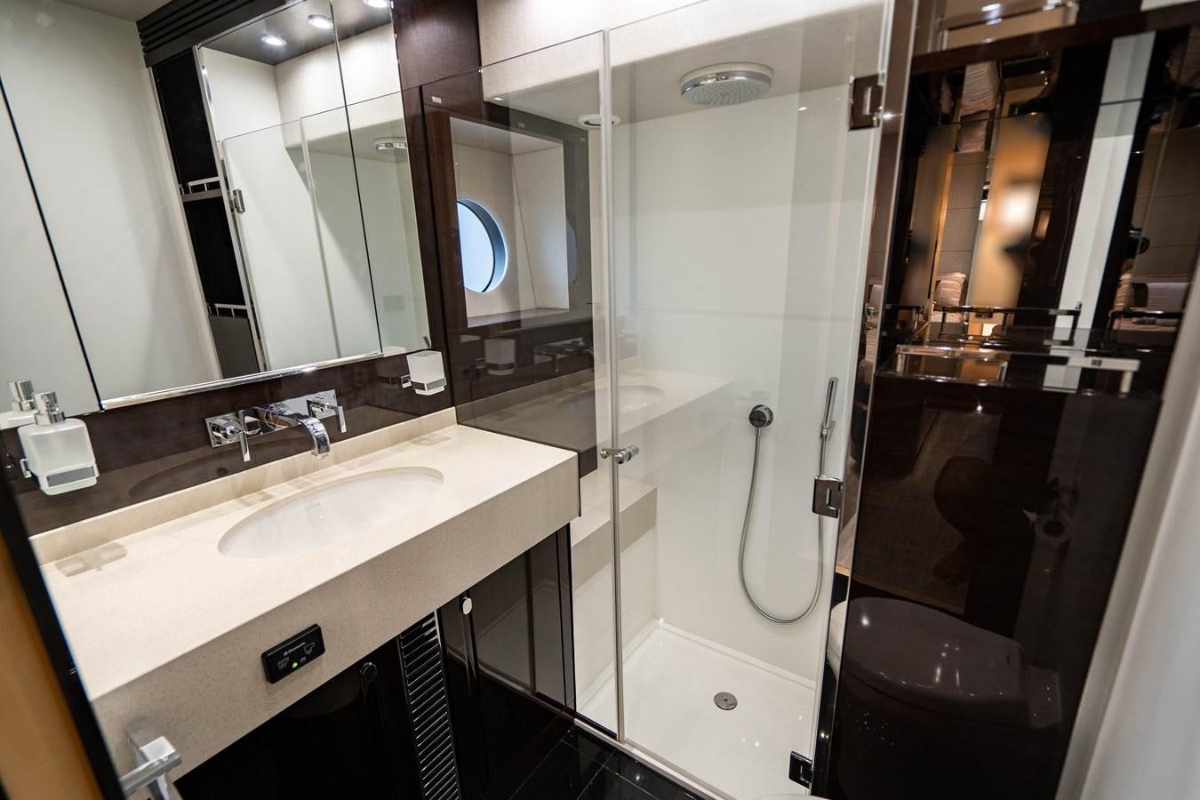 a bathroom with a shower and sink aboard YOLO Yacht for Sale