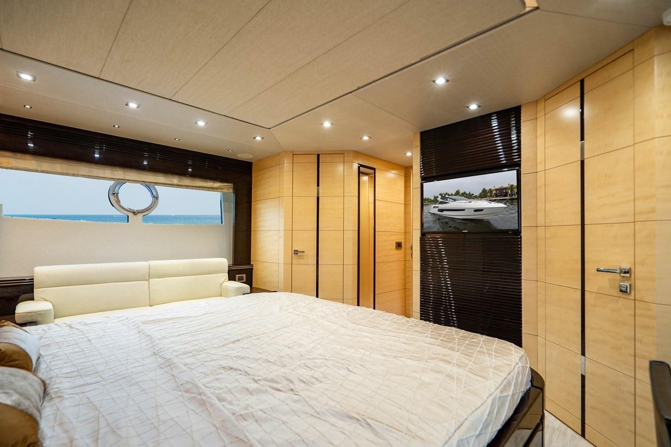 a bedroom with a bed and a closet aboard YOLO Yacht for Sale