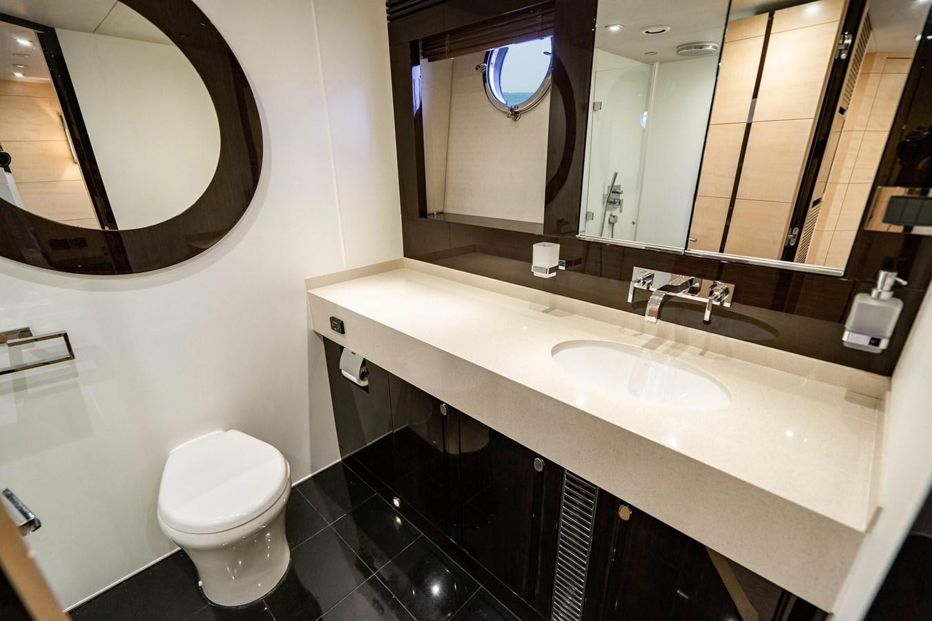 a bathroom with a sink and a toilet aboard YOLO Yacht for Sale