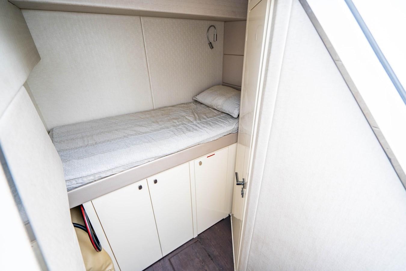 a small bed in a room aboard YOLO Yacht for Sale