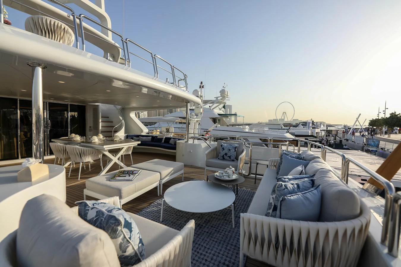 a large patio with a large balcony overlooking a marina aboard DXB Yacht for Sale