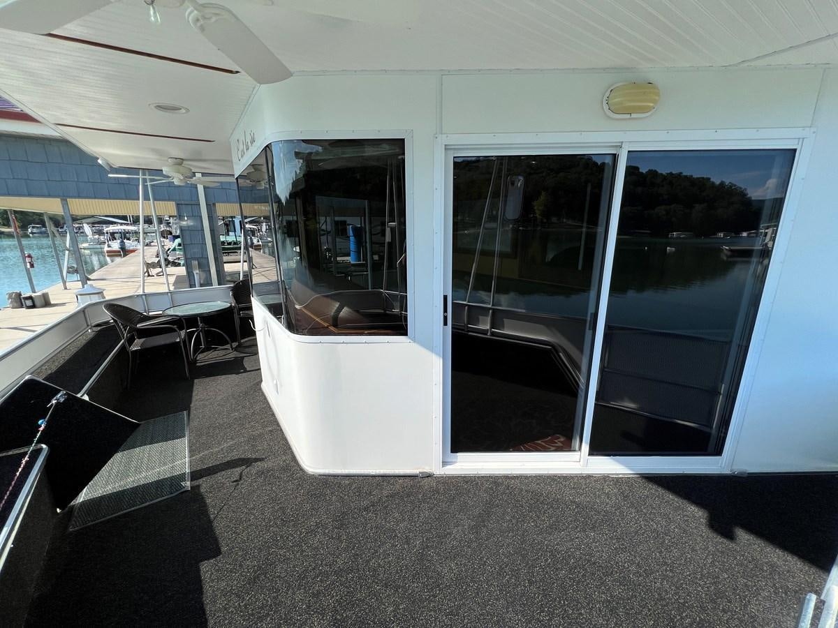 a room with a glass door and windows aboard 2007 STARDUST 19 X 86WB NLCG Yacht for Sale