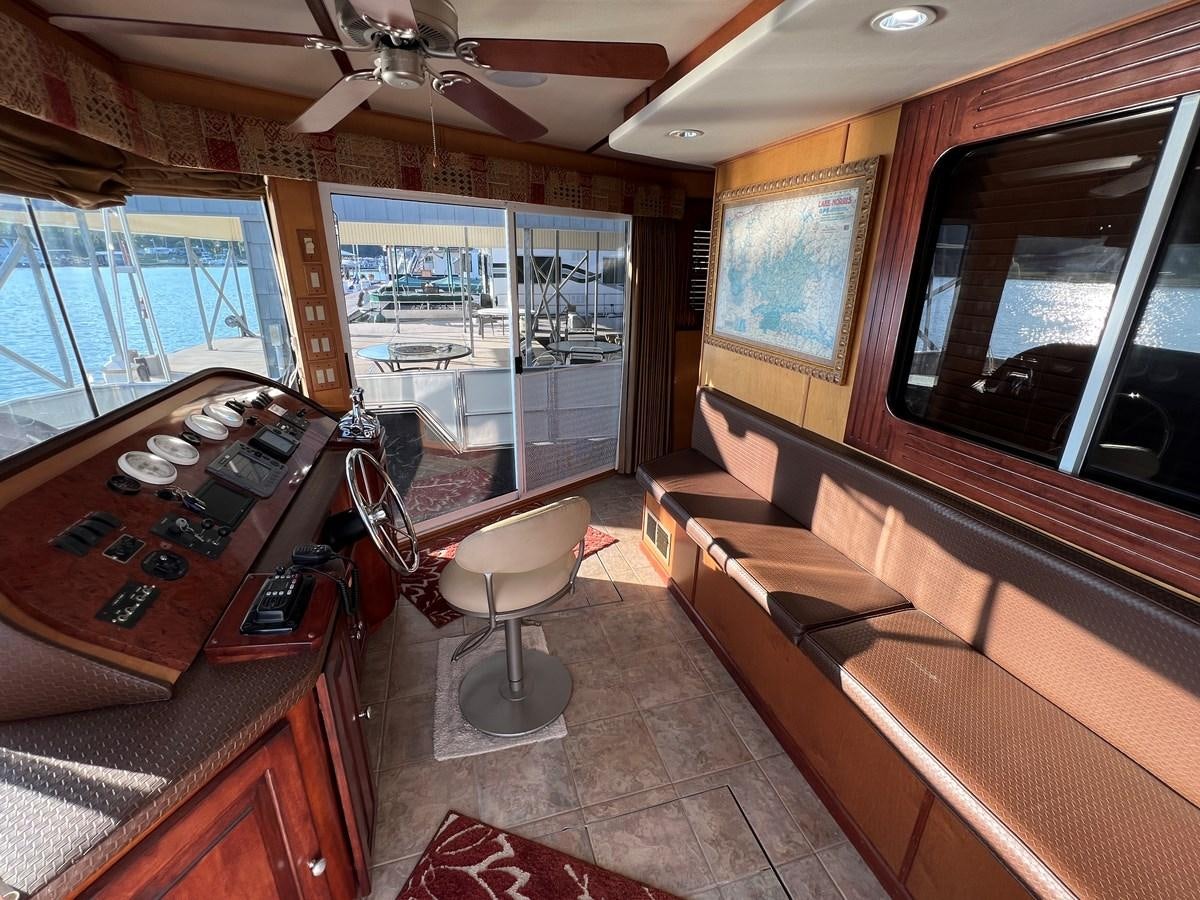 a living room with a wood couch and a wood coffee table aboard 2007 STARDUST 19 X 86WB NLCG Yacht for Sale