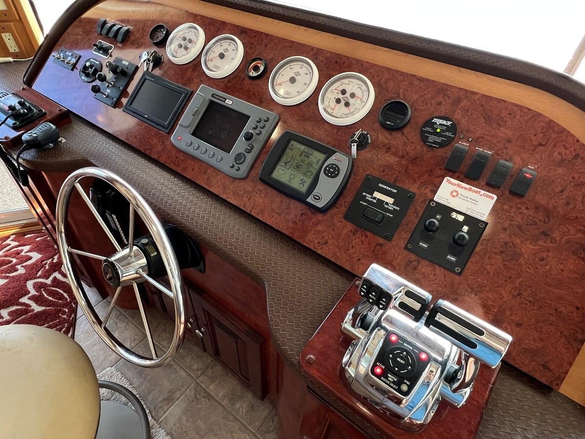 a table with a variety of cell phones on it aboard 2007 STARDUST 19 X 86WB NLCG Yacht for Sale