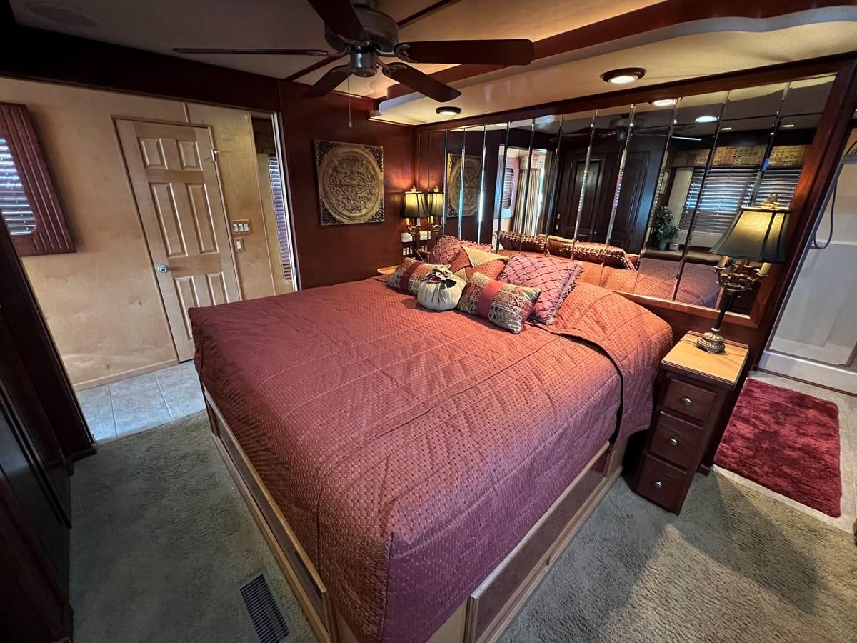 a bedroom with a bed and a fan aboard 2007 STARDUST 19 X 86WB NLCG Yacht for Sale