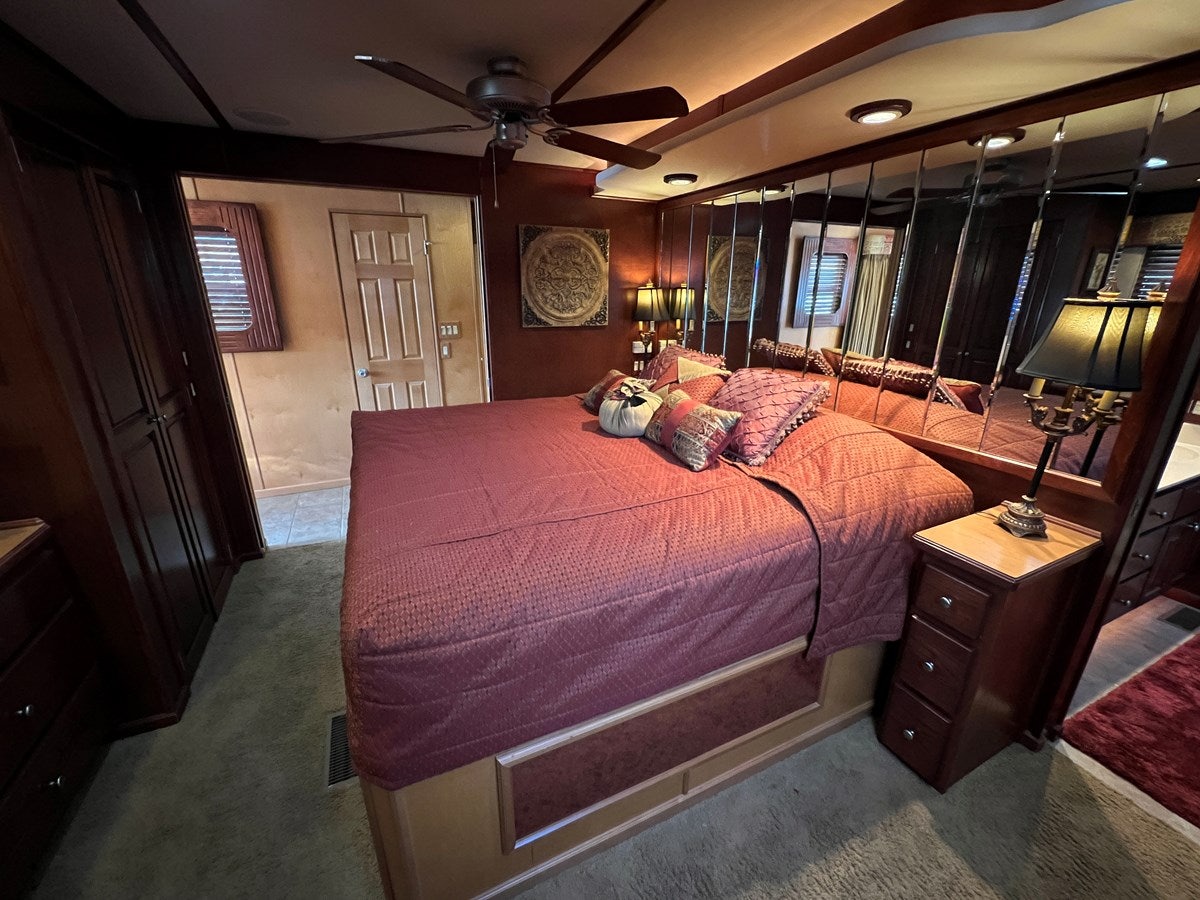 a bedroom with a bed and a fan aboard 2007 STARDUST 19 X 86WB NLCG Yacht for Sale