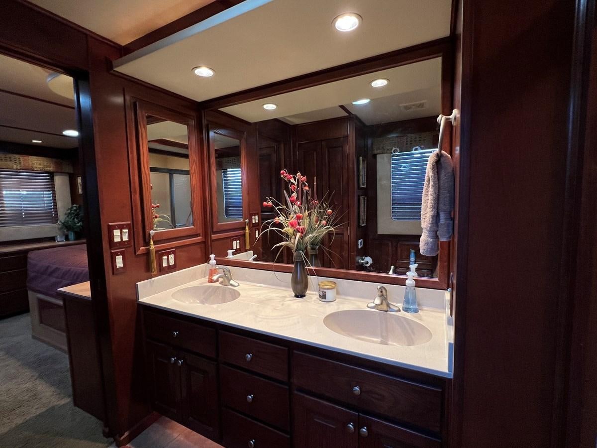 a bathroom with a large mirror aboard 2007 STARDUST 19 X 86WB NLCG Yacht for Sale