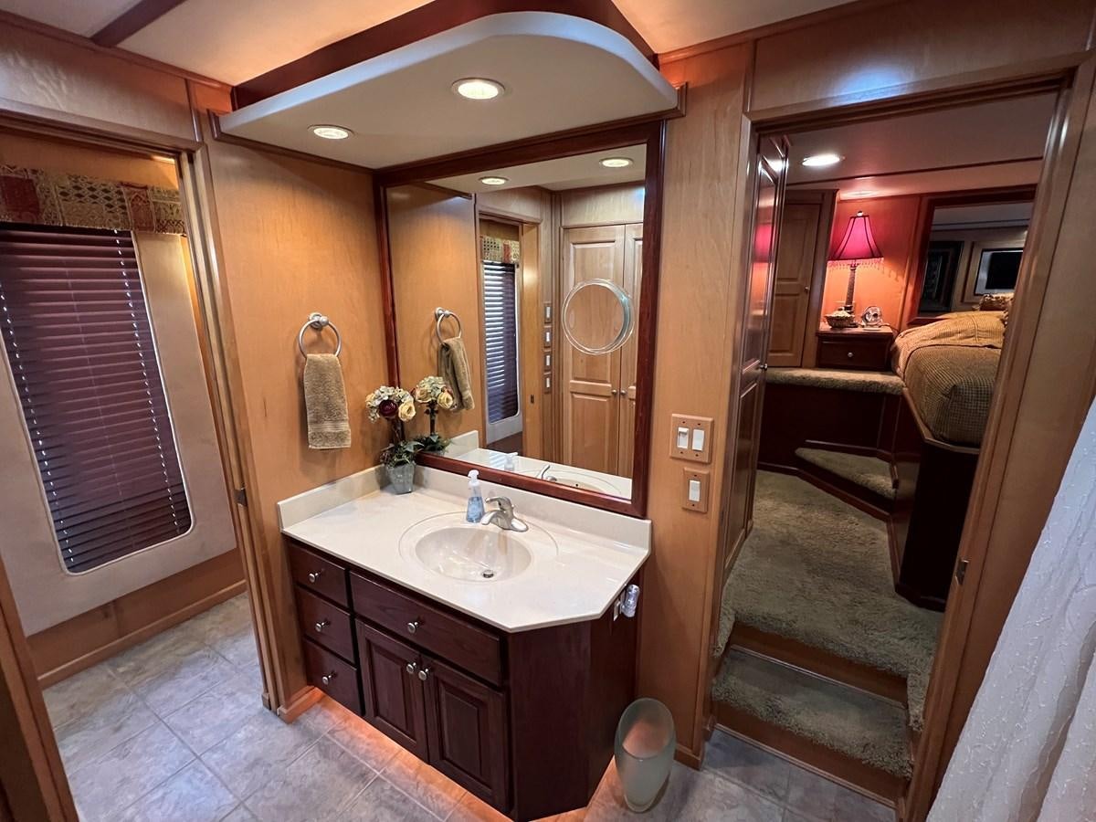 a bathroom with a sink and a mirror aboard 2007 STARDUST 19 X 86WB NLCG Yacht for Sale