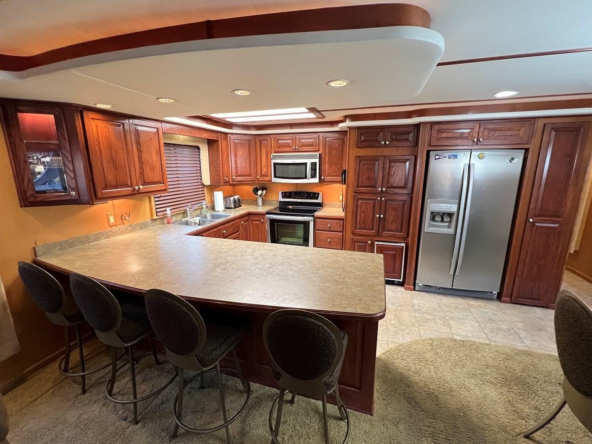 a kitchen with a table and chairs aboard 2007 STARDUST 19 X 86WB NLCG Yacht for Sale