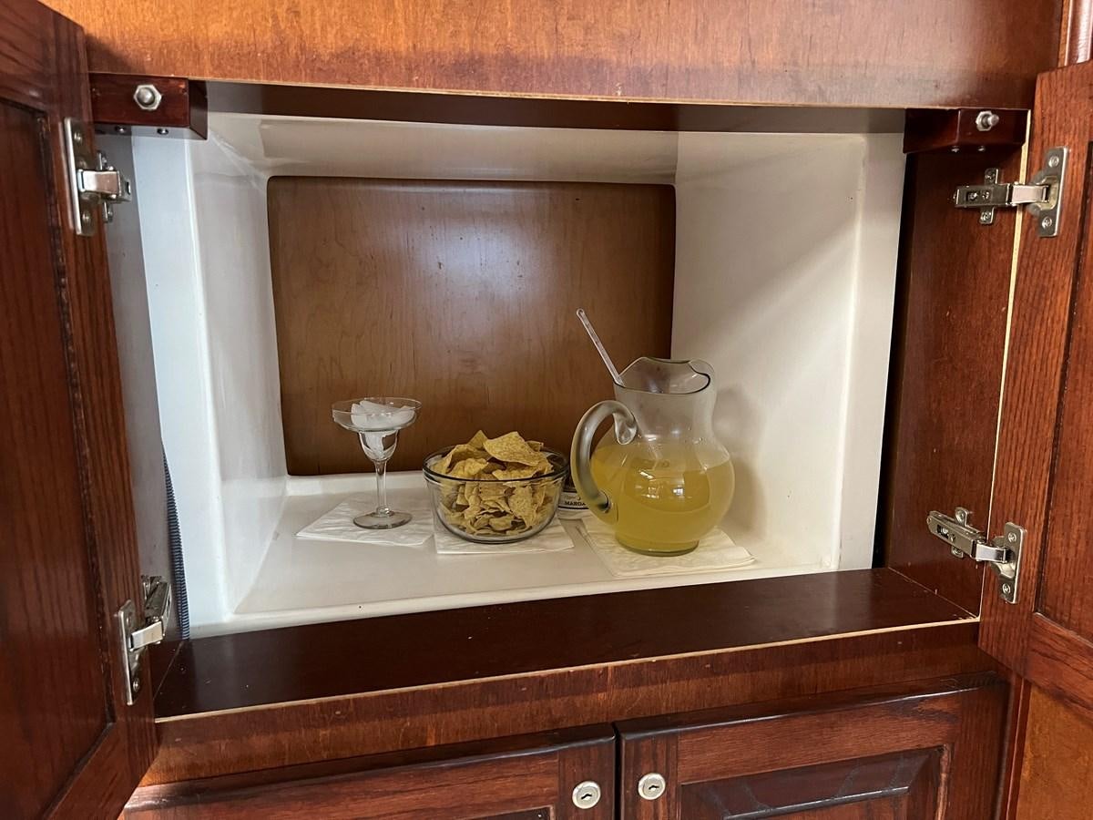 a glass of milk and a bowl of fruit on a counter aboard 2007 STARDUST 19 X 86WB NLCG Yacht for Sale
