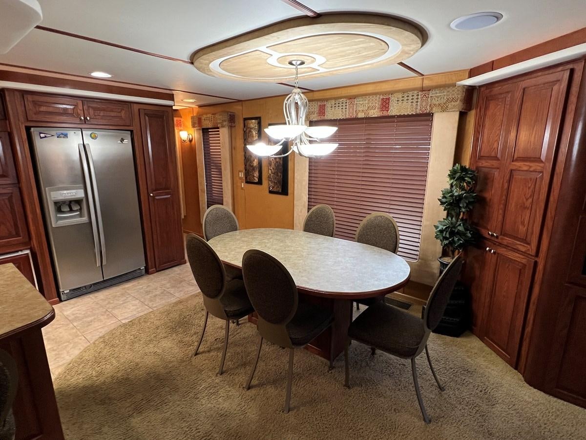 a dining room with a table and chairs aboard 2007 STARDUST 19 X 86WB NLCG Yacht for Sale
