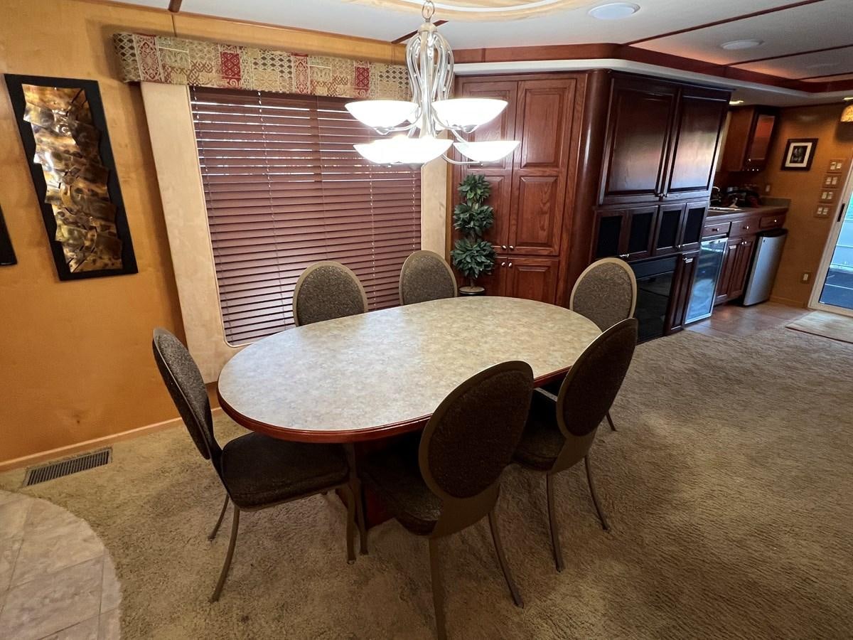 a dining table in a kitchen aboard 2007 STARDUST 19 X 86WB NLCG Yacht for Sale