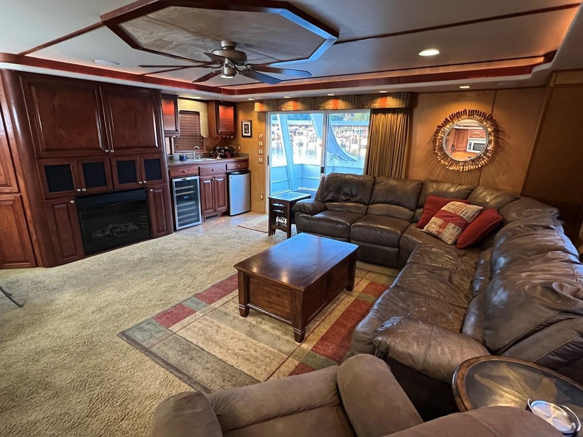 a living room with leather couches and a fireplace aboard 2007 STARDUST 19 X 86WB NLCG Yacht for Sale