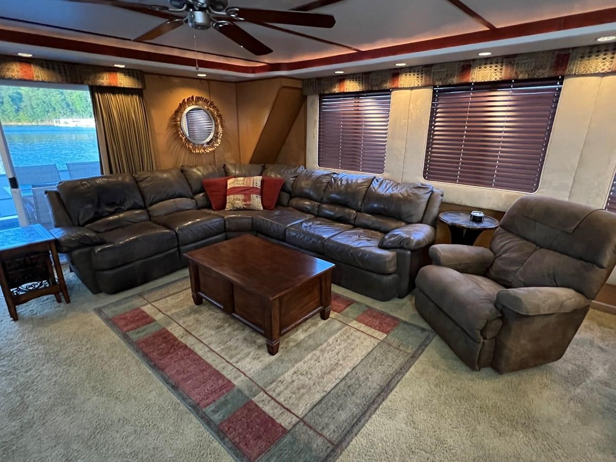 a living room with leather couches aboard 2007 STARDUST 19 X 86WB NLCG Yacht for Sale
