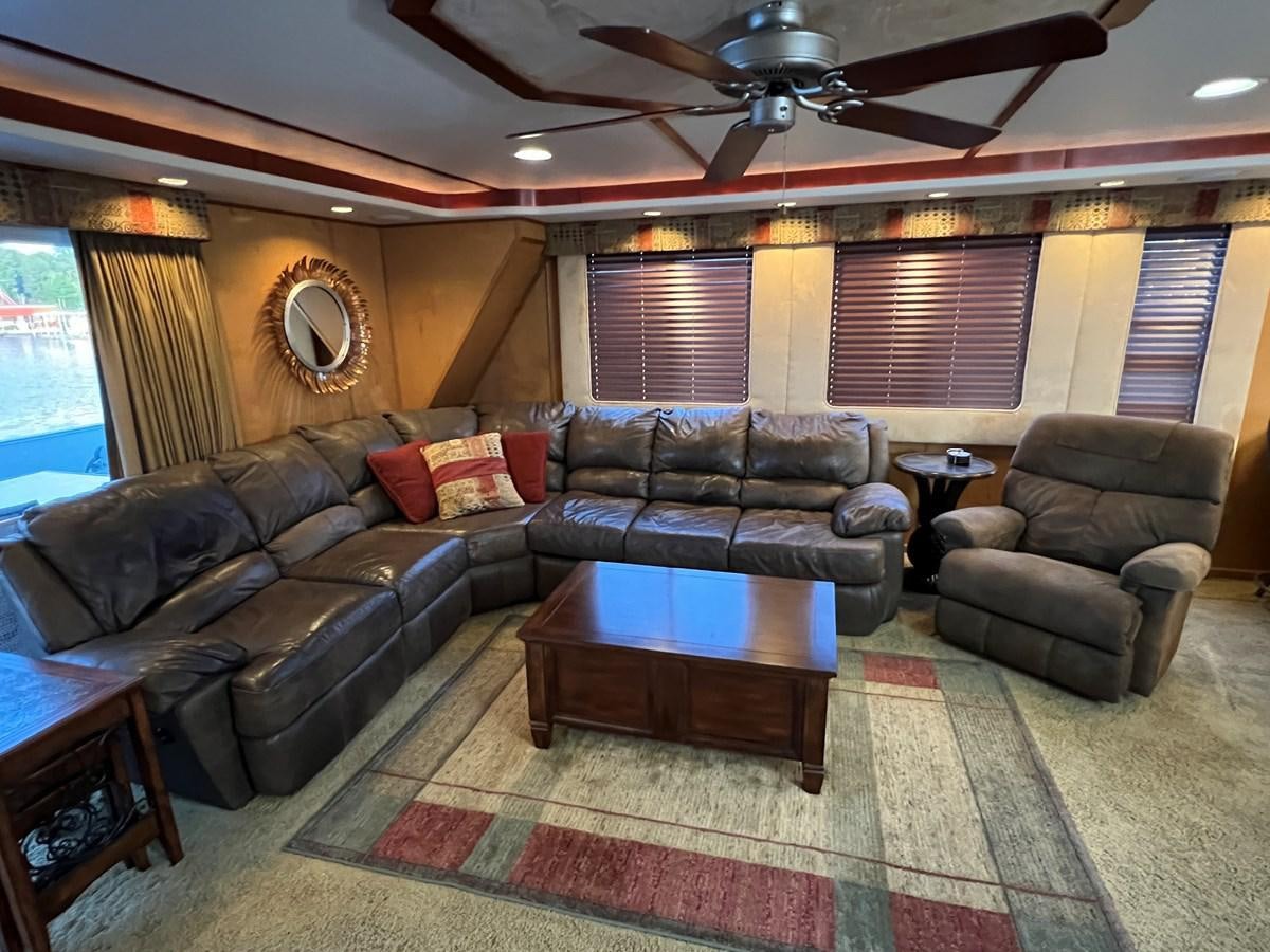 a living room with leather couches aboard 2007 STARDUST 19 X 86WB NLCG Yacht for Sale