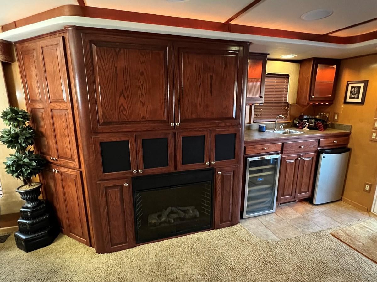 a kitchen with wooden cabinets aboard 2007 STARDUST 19 X 86WB NLCG Yacht for Sale