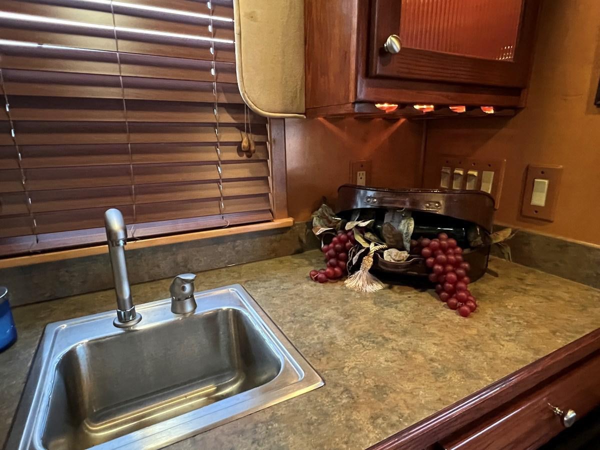 a kitchen with a sink and a stove aboard 2007 STARDUST 19 X 86WB NLCG Yacht for Sale